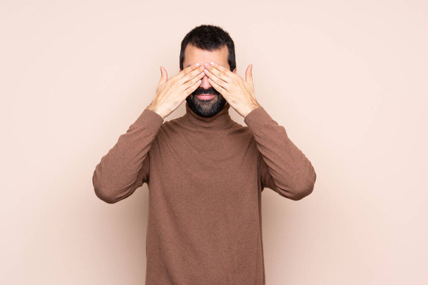 Man over isolated background covering eyes by hands - Photo, Image