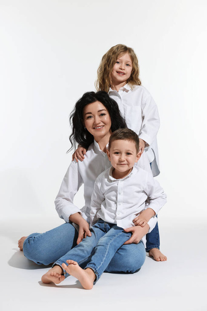 Little children with their mother on white background - Photo, image