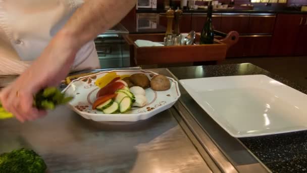 Horizontal dolly shot of chef standing near metal table - Video, Çekim