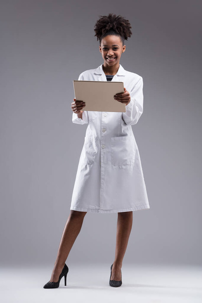 scientist with a modern twist, she showcases how style and professionalism can coexist, tablet in hand - Photo, Image