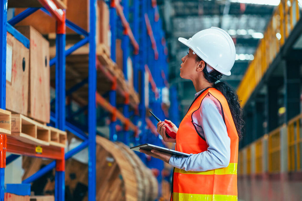 the worker is depicted amidst the organized chaos of a bustling warehouse, engaged in tasks such as inventory management, order fulfillment, or logistical operations. - Photo, Image