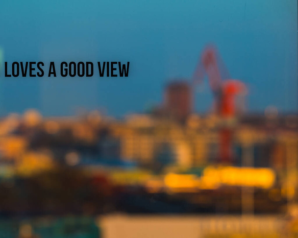 Göteborgin hämärä taivaanranta, Ruotsi, asettaa kauniin, epäselvän taustan ikkunaksi, johon kirjoitettu viesti Loves a Good View luo ainutlaatuisen, mietiskelevän maiseman. T artikla - Valokuva, kuva