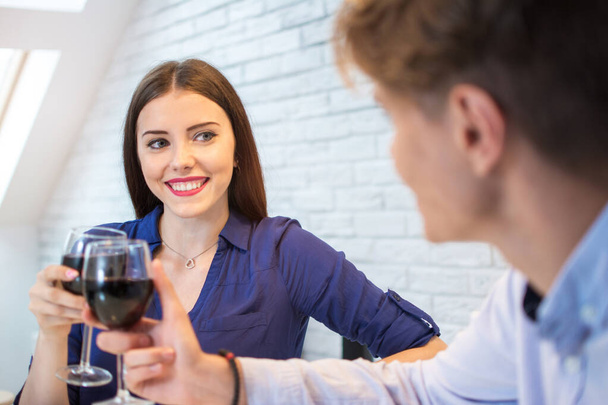 Happy couple romantic date drink glass of red wine at home - Photo, Image