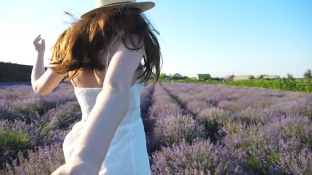 Young woman holding male hand and running through lavender field. Happy couple having fun on blooming flower meadow. Smiling girl jogging looking back into camera. Nature landscape. POV Slow motion. - Footage, Video