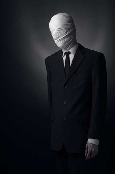Internet meme and terrible character Halloween theme: very tall burly man with long arms in a suit with bandaged face fabric, an unknown killer in the suit, The Slender Man, Secret legend of the city - Photo, Image