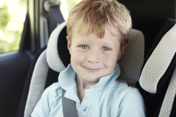 Boy in child's car sea - Foto, imagen