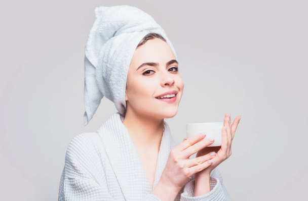 Cosmetic skincare product. Face beauty care. Portrait of beautiful woman with facial cream in hand. Sexy female with fresh clean soft skin - Photo, Image
