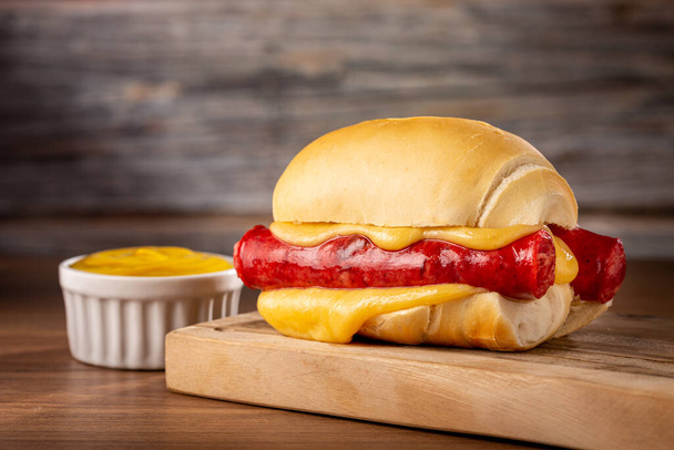 Sausage sandwich with melted cheese. - Photo, Image