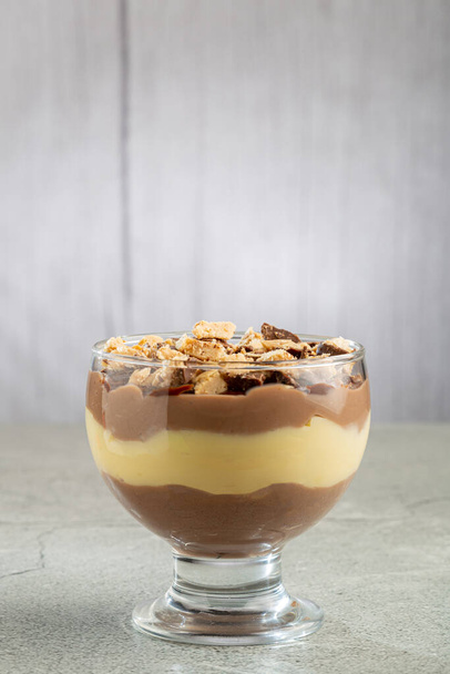Dessert in the glass. Pastry cream dessert with chocolate ganache. - Photo, Image