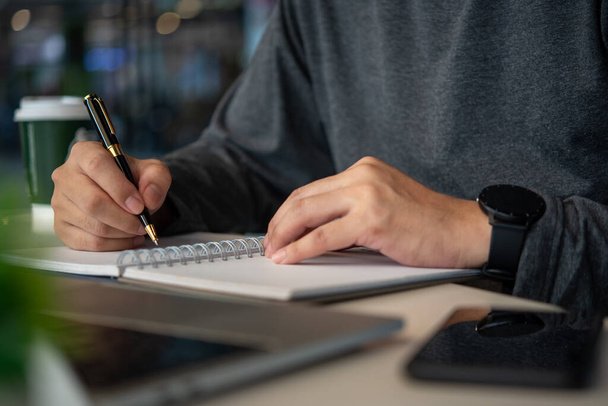 man hands with pen writing on notebook at table.learning, education and work.writes goals, plans, make to do and wish list on desk.	 - Fotoğraf, Görsel