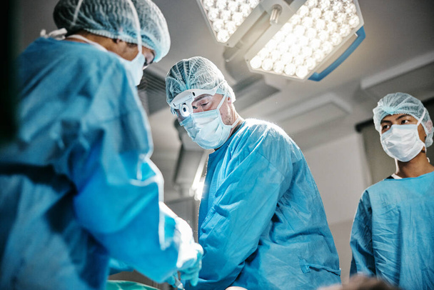 Theatre, icu or surgeons with teamwork for emergency, accident or healthcare in hospital clinic. Surgery operation, medical or doctors in surgical collaboration in operating room to support or help. - Photo, Image