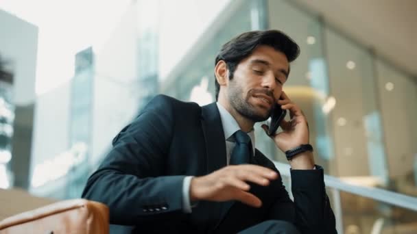 Smart business man calling phone to manager while discuss about business plan. Skilled executive manager talking to phone with blurred background. Investor celebrate successful project. Exultant. - Footage, Video