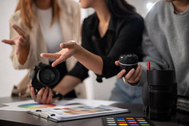 A cropped image of a professional, experienced female photographer working with her team in the studio, planning and briefing the photoshoot concept. - Photo, Image