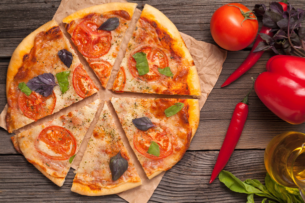 Sliced traditional italian pizza margherita with tomatoes, olive - Zdjęcie, obraz