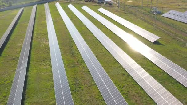 Rijen van zonnepanelen geïnstalleerd op het veld. Luchtopname van zonnecentrales die duurzame groene energie opwekken. Zon reflectie op zonnepaneel oppervlak. Productie van schone ecologische energie. Sluitingsdatum - Video