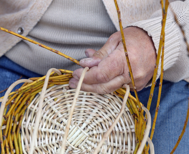 Senior craftsman creates a handmade wicker basket - Photo, Image
