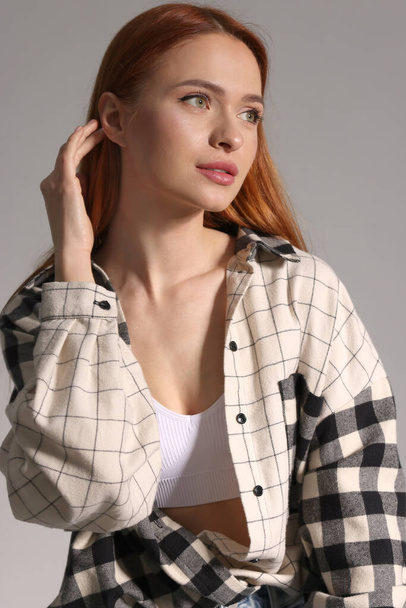 Beautiful young woman in stylish shirt on gray background - Fotografie, Obrázek