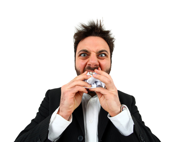Νέος θυμωμένος επιχειρηματίας τρώγοντας balled χαρτί. - Φωτογραφία, εικόνα