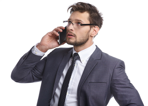 Emotional young man is talking on the phone. The human face, exp - Foto, imagen