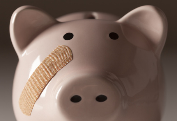 Piggy Bank with Bandage on Face - 写真・画像