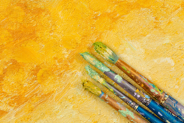 Artists vintage brushes on yellow artistic background  - Photo, Image