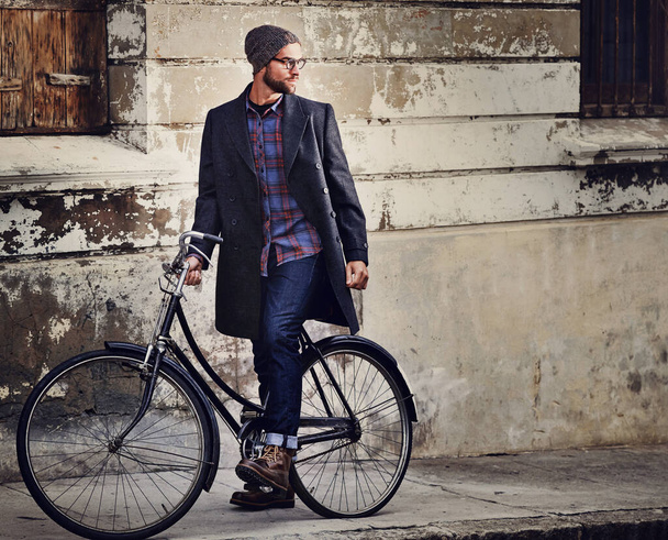 Bike, fashion and man in city for travel on winter vacation, adventure or holiday with retro style. Vintage, stylish and male person on bicycle for cycling with beanie and coat for outfit in town - Photo, Image