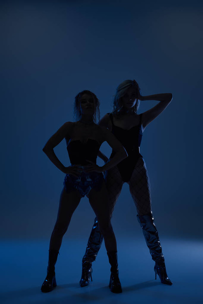 Δύο σέξι νεαρές γυναίκες σε μαγευτικές πόζες να στέκονται δίπλα δίπλα.. - Φωτογραφία, εικόνα