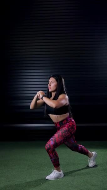 Mexican trainer doing lunges in the gym. Advertising video of a woman in sports clothing exercising - Footage, Video