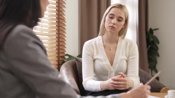 Psychological consult on mental health or seeking help from professional, psychiatrist holding patients hand on therapy while making diagnostic on mental illness. Mental treatment session. Blithe - Footage, Video
