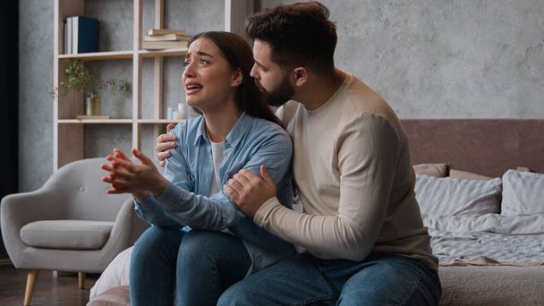 Caucasian man apologizing husband calming anxious annoyed wife ask forgiveness after family conflict crying tears woman emotional complain listen to spouse apologies quarrel relations crisis breakup - Photo, Image
