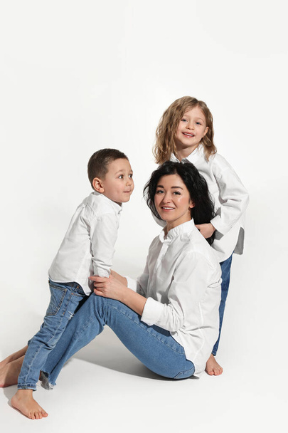Little children with their mother on white background - 写真・画像