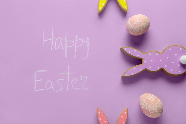 Phrase Happy Easter and festive decor on purple background - Photo, Image