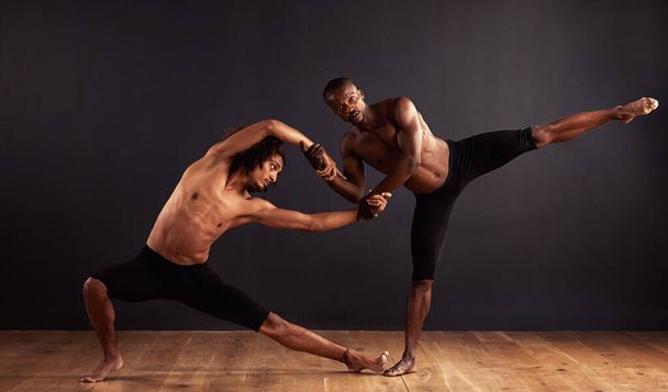 Performance, theatre and moving of men for dance, creative and art of body, team and passion. Black background, male people and partners with pride, confident and balance for ballet and stage. - Photo, Image