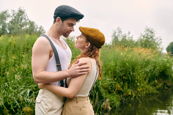 Egy férfi és egy nő közel állnak egymáshoz egy zöld parkban, a kapcsolat nyilvánvaló a nyugodt pózokban.. - Fotó, kép