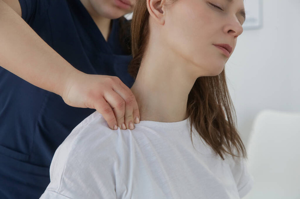 Woman at the doctors office on chiropractic, physiotherapy or myodynamic treatment to treat and prevent musculoskeletal problems, reduce pain and muscle tension. - Photo, Image