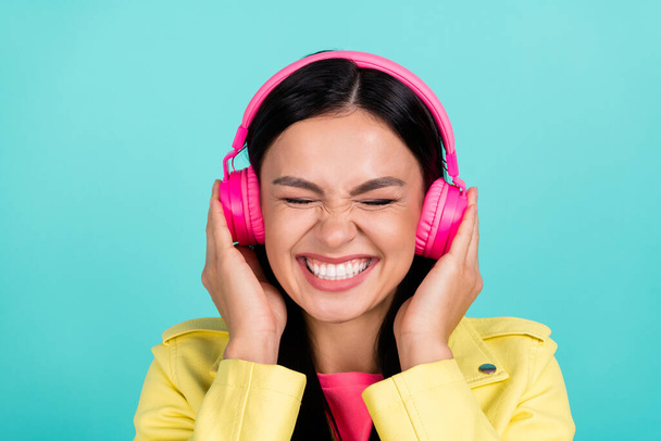 Photo of young excited girl listen radio pop music headphones isolated over turquoise color background. - Foto, Imagem