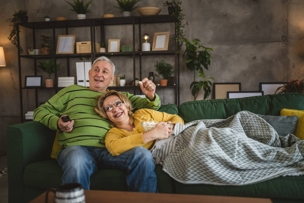 Couple caucasian man and woman sit at home on sofa bed watch tv movie - Photo, Image