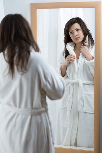 Woman looking in the mirror - Foto, imagen