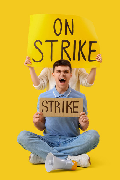 Protesting people with placards on yellow background. Strike concept - Photo, Image