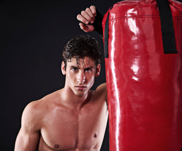 Fitness, mma and portrait of man with punching bag in studio for exercise, challenge or competition training. Power, muscle or champion boxer at workout with confidence, fight and black background. - Foto, Imagen