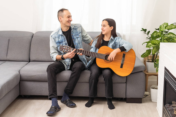 Happy family Father and daughter playing guitar. Fathers day. High quality photo - Photo, Image