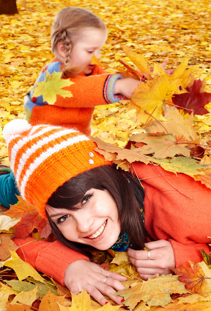 Happy family with child on autumn orange leaves. - Fotografie, Obrázek