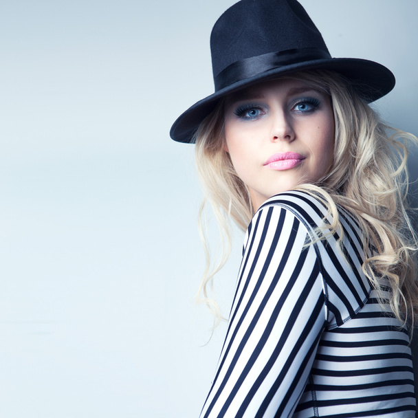 Woman wearing hat and stripy top - Photo, Image