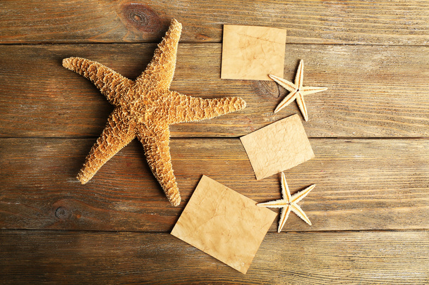 Card blanks with sea stars on wooden background - Photo, Image