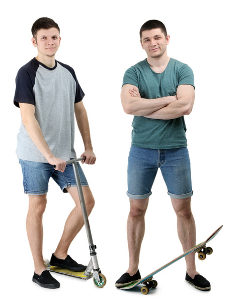 Twee knappe jonge mannen met skate en scooter geïsoleerd op wit - Foto, afbeelding