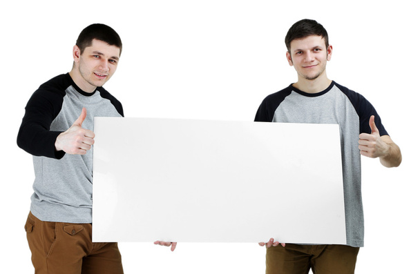 Two handsome young men holding blank poster isolated on white - Foto, afbeelding