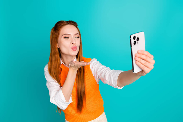 Photo of adorable lovely flirty girl blogger dressed stylish orange clothes send kiss followers isolated on cyan color background. - Φωτογραφία, εικόνα