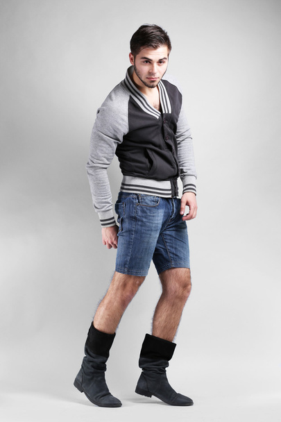 Man in casual style on gray background - Foto, Imagem