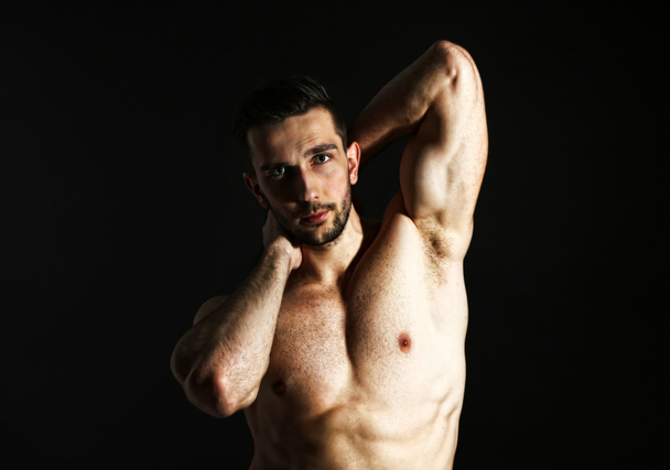 Muscolo giovane uomo su sfondo nero
 - Foto, immagini