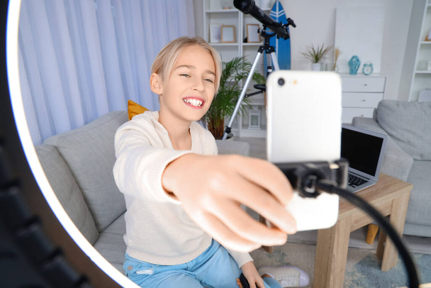 Blogger adolescente ajustando celular para gravação de vídeo em casa - Foto, Imagem